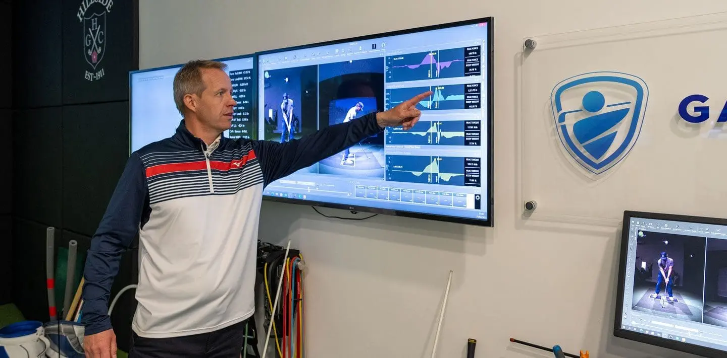 Gareth Benson analysing swing data on screen at Hillside Golf Club