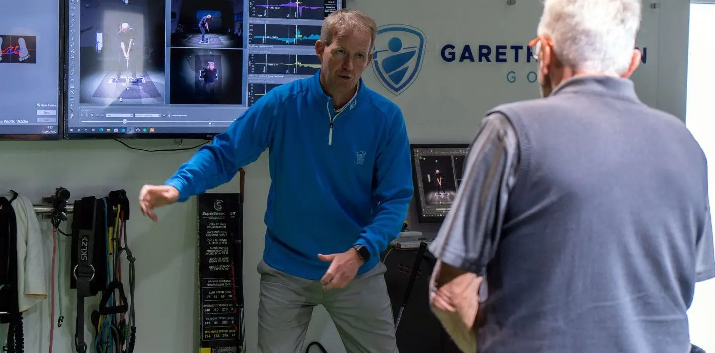 Gareth Benson coaching a golfer in the performance studio